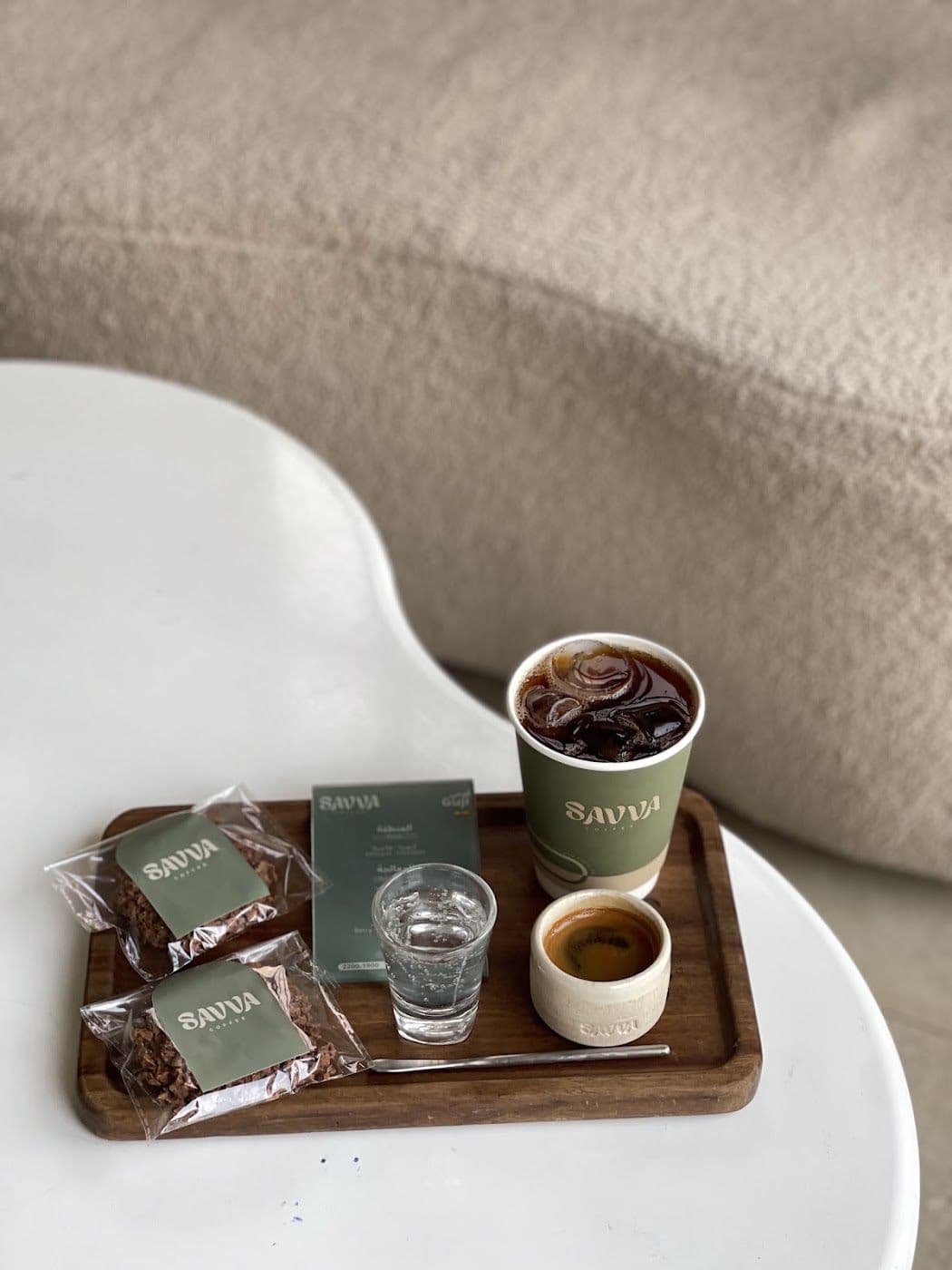A SAVVA tray with an iced coffee, an espresso cup and a glass of water